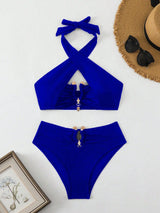 Blue bikini set with a hat, sunglasses, and framed picture on a white background