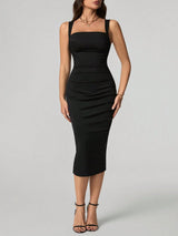 Black dress worn by a model on a gray background