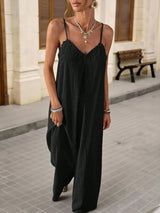 Woman wearing a black slip dress on a street.