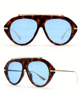 Tortoiseshell sunglasses with blue lenses on a white background