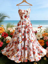 Floral dress on a hanger with a beach and flowers in the background