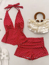 Red polka dot swimsuit with white polka dot shorts and a sequined bag on a light background