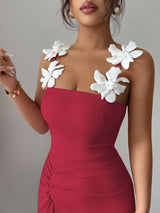 Red dress with white floral shoulder details on a neutral background