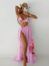 Person wearing a pink bikini and matching cover-up against a white background