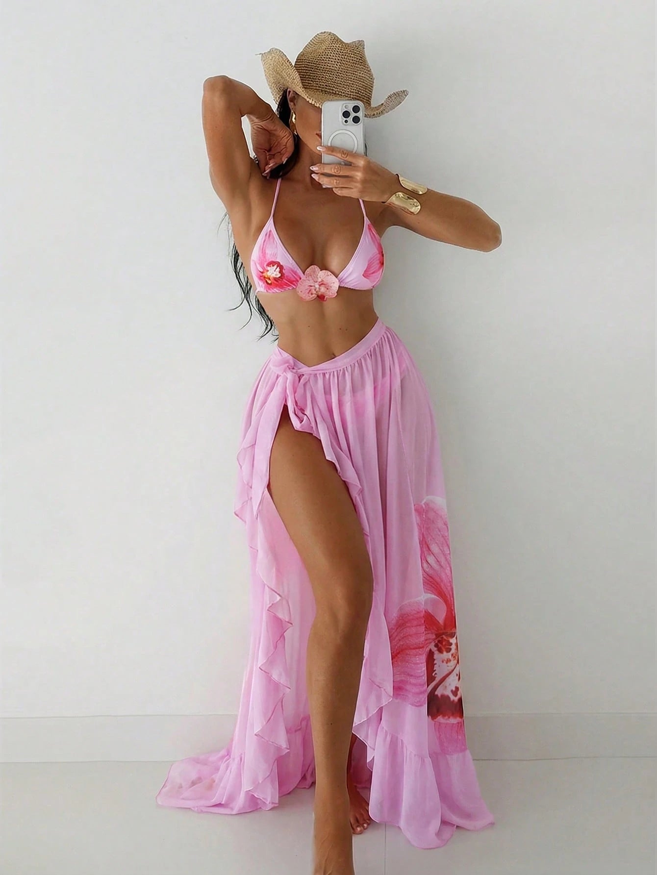 Person wearing a pink bikini and matching cover-up against a white background