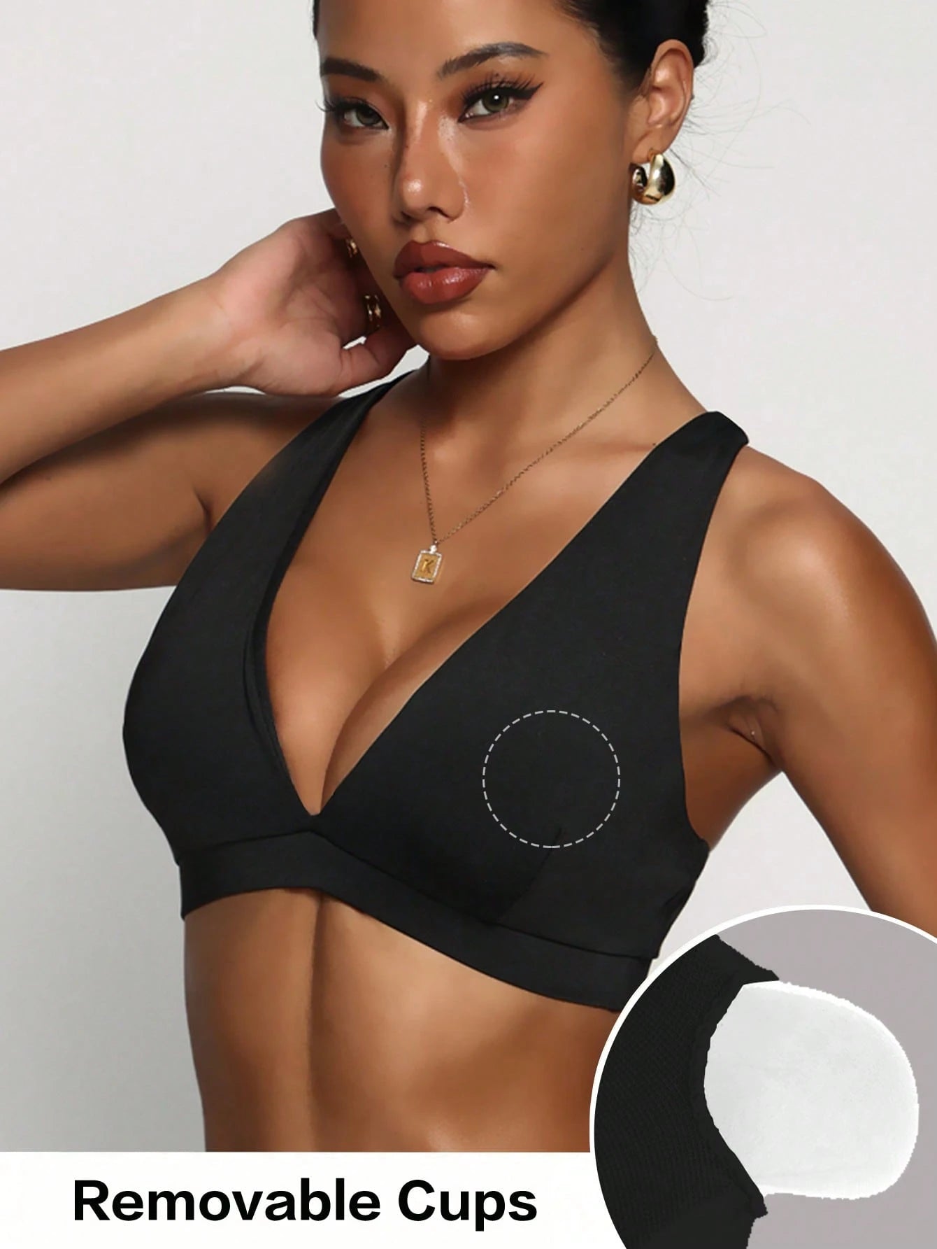 Black sports bra with removable cups on a model against a white background